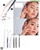 A magazine page with a picture of a woman applying eyeliner.